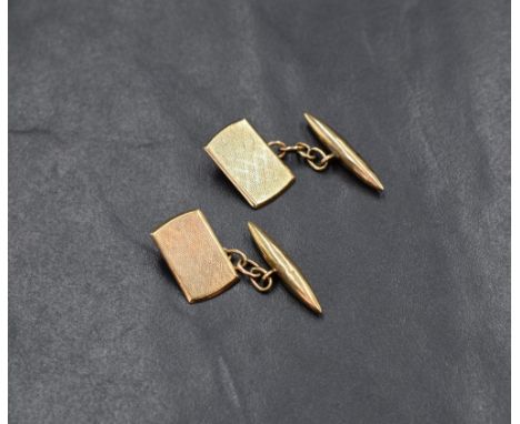 A pair of gold cufflinks, the rectangular panels having engine turned decoration with a chain link and T-bar, having rubbed h