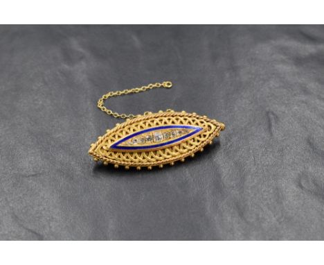 A 15ct gold locket brooch of lozenge form having nine graduated old cut diamonds, approx 0.5ct total within a blue enamelled 