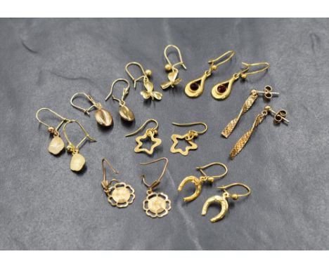 Eight pairs of 9ct gold and yellow metal earrings for pierced ears, including coffee bean, clover leaf, horse shoe etc, appro