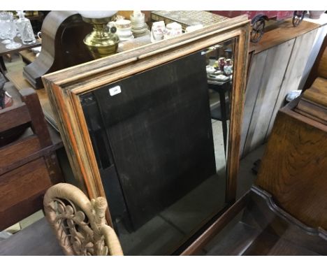 A large pine framed and bevel edged mirror 