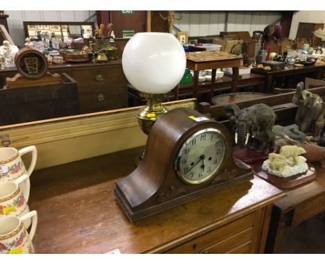 An Enfield oak cased mantel clock; and a brass oil lamp