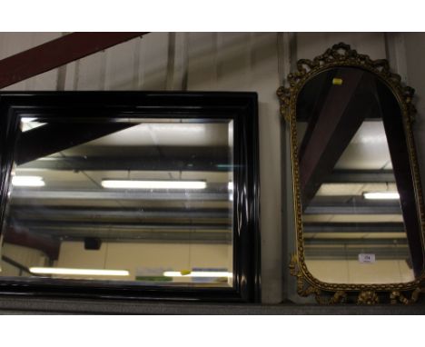 A gilt metal wall mirror; and an ebonised and bevel edged mirror 