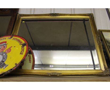 A large gilt framed and bevel edged wall mirror 