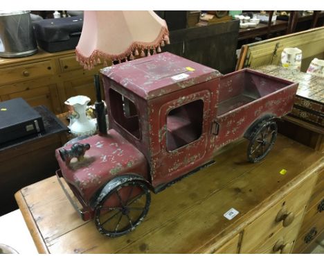 A child's red painted vintage truck 
