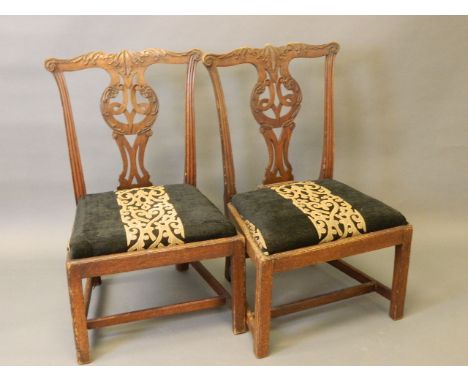 A pair of C19th Chippendale style side chairs with well carved and pierced backs, on square supports and 'H' stretchers (AF r