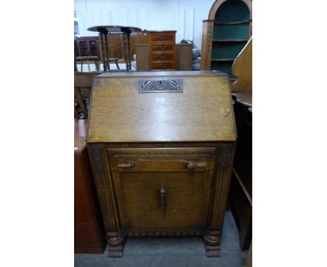 An Art Deco carved oak bureau 