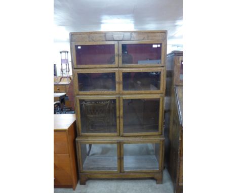 An Art Deco oak four tier sectional stacking bookcase 