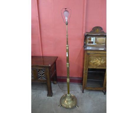 An Arts and Crafts brass telescopic floor standing lamp 