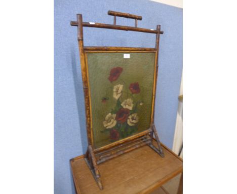 A Victorian Aesthetic Movement painted glass and bamboo fire screen 