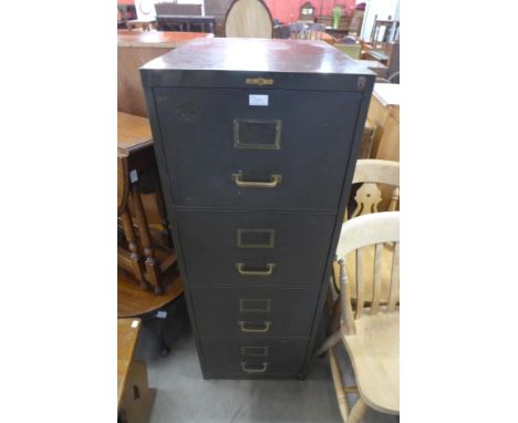 A vintage green metal filing cabinet 