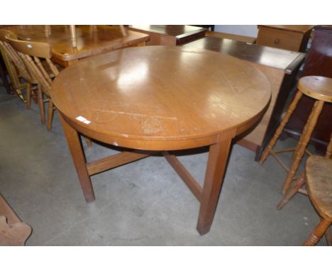 An Art Deco style oak circular dining table 