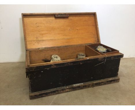 A pine carpenters trunk with contents to include oil can, planes, vintage saws. W:85cm x D:38cm x H:37cm