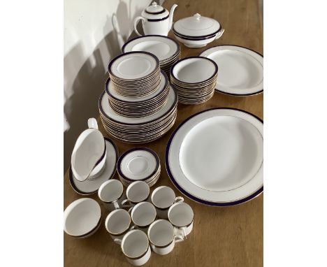 A Royal Worcester twelve person dinner service in the Howard design with blue and gilt borders to include tureen and two larg