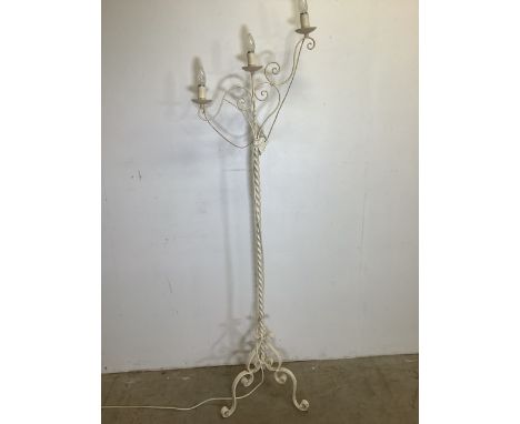 A metal candelabra style standard lamp, cream painted on tri base.