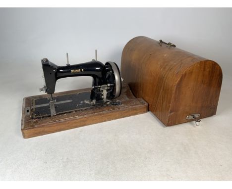 A Singer Harris K sewing machine in wooden carry case with key.
