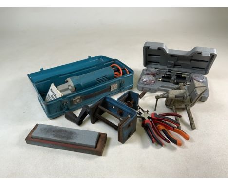 An angle grinder, sanding drum sets and other tools including a large set square.