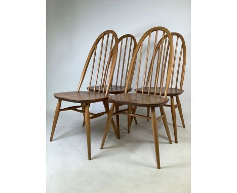 A set of four Ercol blonde elm and beech mid century dining chairs. W:43cm x D:41cm x H:97cm