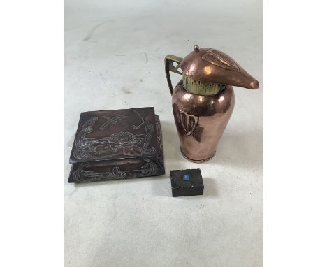 Three Arts and Crafts items to include a lidded copper and brass jug, a copper lidded box and a pewter mounted box with inset