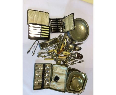 A large quantity of silver plated items including some boxed items- knifes, fork and trays.&nbsp;