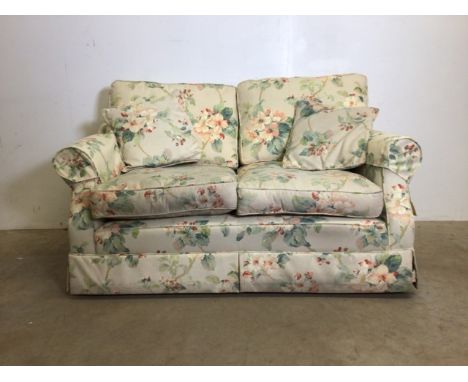 A two seater sofa recently upholstered by Plums with floral design.W:140cm x D:86cm x H:87cm