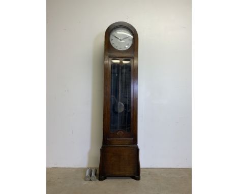 An Arts and Crafts style oak domed top longcase clock. Three weights and a pendulum.W:46cm x D:26cm x H:188cm