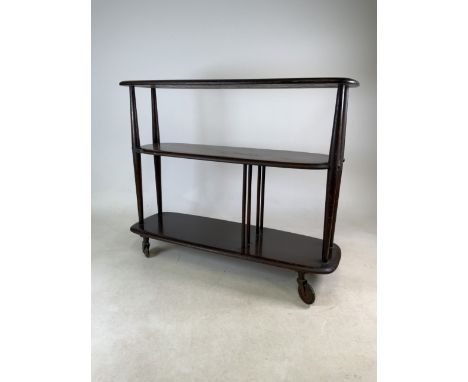 An Ercol stained oak three tier buffet on large castors. W:92cm x D:32cm x H:75cm