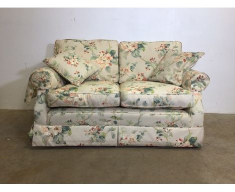 A floral design two seater sofa recently upholstered by Plums. W:140cm x D:85cm x H:80cm