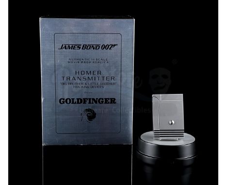FACTORY ENTERTAINMENT - Made from metal. Smaller gold-coloured device adheres to larger device via a magnet. Makes beeping so
