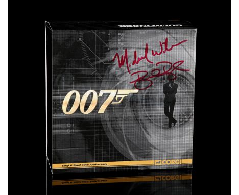 CORGI - Two gold-plated vehicles in original box. Outer card sleeve signed by Barbra Broccoli and Michael G. Wilson in red in