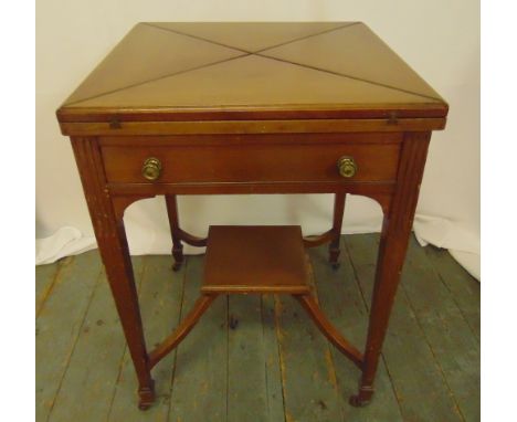 A mahogany envelope card table, the single drawer with brass handles on four tapering rectangular legs, 75.5 x 54 x 54.5cm