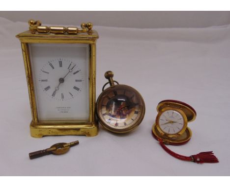 A Victorian brass carriage clock of customary form to include key, a glass globular desk watch and a Perdal 1960s travel alar