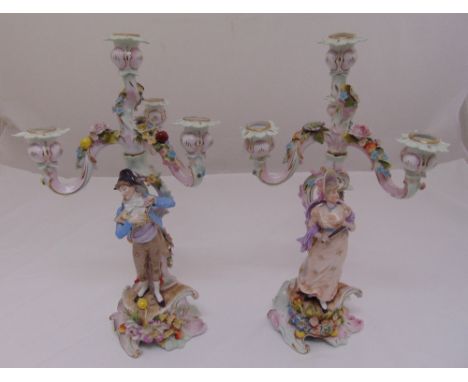 A pair of Sitzendorf figural three branch candelabra on naturalistic bases, 44cm (h)