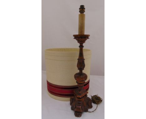 A carved wooden table lamp on triform base with detachable shade, 62cm (h)