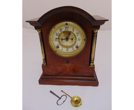 An Edwardian bracket clock of architectural form, silvered dial, Roman numerals, two train movement, to include key and pendu