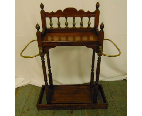 A rectangular mahogany umbrella and stick stand with brass mounts on rectangular plinth, 82.5 x 64 x 28.5cm