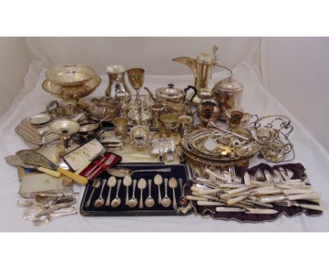A quantity of silver plate to include a Middle Eastern coffee pot, cake stands, a teapot and cased teaspoons