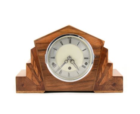 An Art Deco style mantel clock, circular dial with Roman numerals to the chapter ring, 23cm high; and a small oak barometer. 