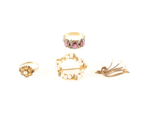 A collection of two gold and pearl brooches, a garnet ring and a signet ring, a yellow metal 27mm diameter open garland brooc