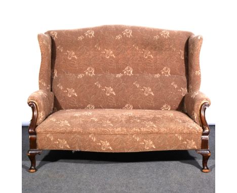 An Edwardian wing-back settee, uncut maquette upholstery, scrolled arms, cabriole legs, width 142cm.