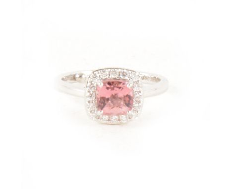A kunzite and diamond cluster ring, the 6mm faceted cushion shaped kunzite four claw set and surrounded by fifteen brilliant 