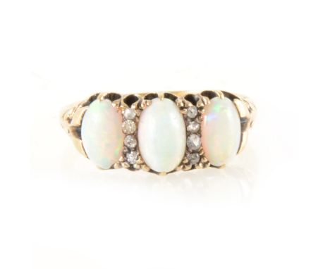 An opal and diamond half hoop ring, three oval cabochon cut opals claw set and spaced by two vertical rows each of four rose 