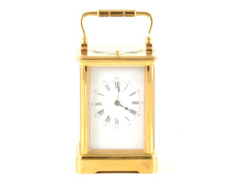 A brass carriage clock, French movement, white enamel dial with Roman hour numerals and Arabic minute markers, 12.5cm.