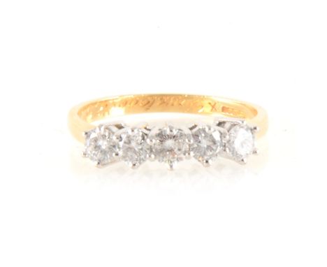 A diamond five stone ring, the brilliant cut diamonds, uniform in size claw set in an 18 carat yellow and white gold half hoo