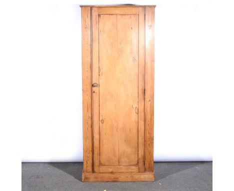 A pine cupboard, panelled door enclosing a single shelf, width 79cm, height 187cm.