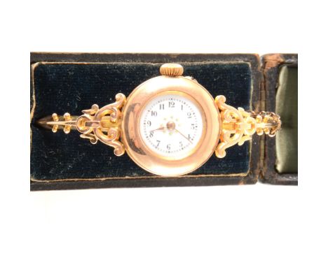 A Edwardian fob watch mounted onto a bangle, circular white enamel dial with an arabic numeral chapter ring in a 24mm case (b
