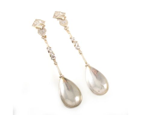 A pair of white metal spoons, Austro-Hungarian import mark, double headed eagle motif with castle and lion in centre, depicti