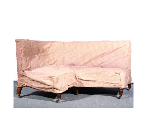 A Victorian walnut corner sofa, with old loose covers, turned and ringed legs, the angles 135cm and 125cm.