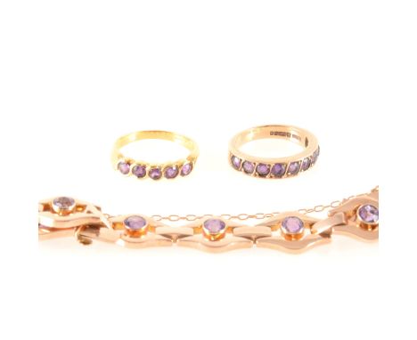 An amethyst bracelet and two amethyst rings, the rose metal bracelet marked 9ct, having eleven 11.5mm polished boat shape lin