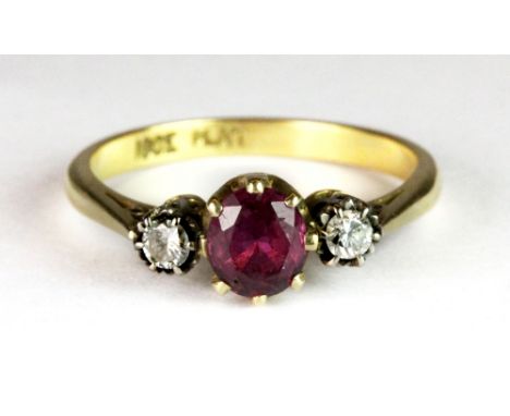 An 18ct gold and platinum ring set with a ruby and two diamonds (M).