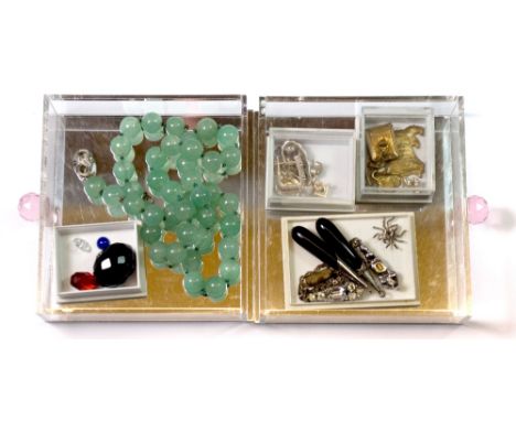 A jade necklace and other jewellery items.